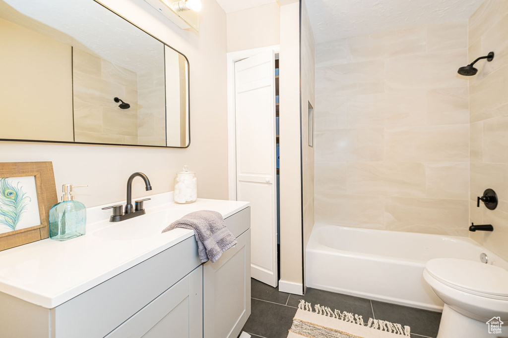 Full bathroom with tile patterned floors, vanity, and  shower combination
