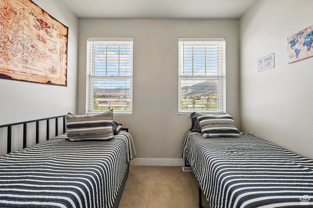 Bedroom featuring carpet floors and baseboards