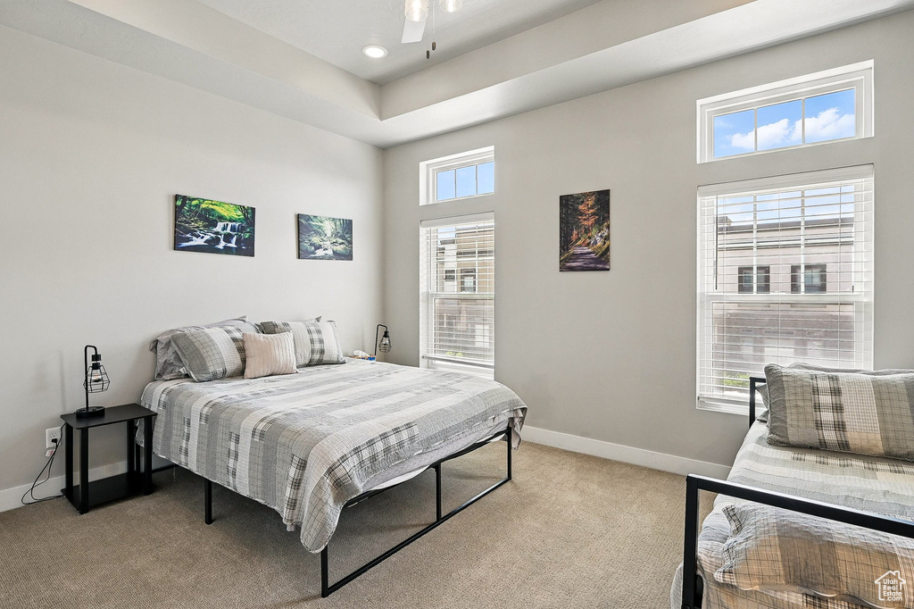 Bedroom featuring light colored carpet, baseboards, recessed lighting, and a high ceiling