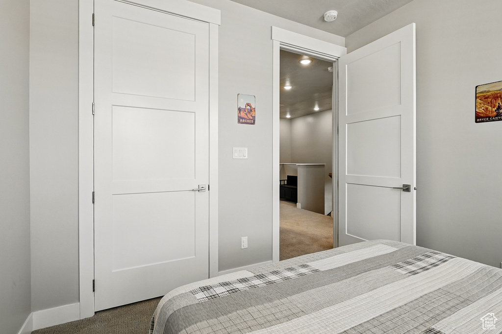 Carpeted bedroom with baseboards