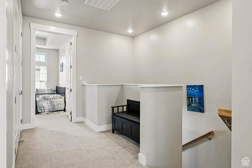 Hallway with an upstairs landing, carpet, baseboards, and recessed lighting