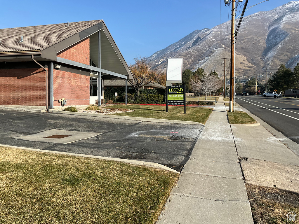 View of home's exterior featuring a mountain view, brick siding, and a tiled roof
