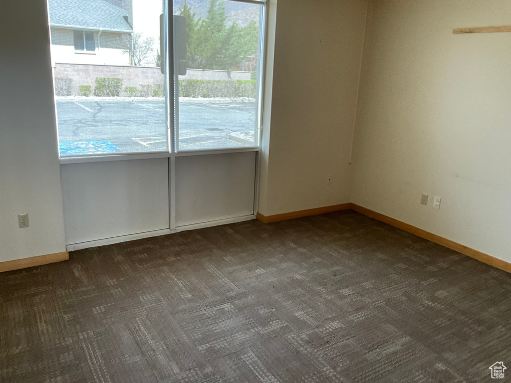 Carpeted spare room with baseboards