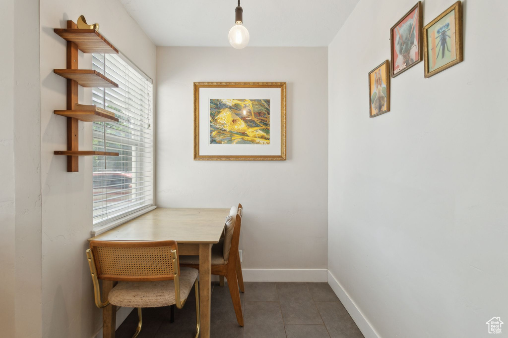 Tiled dining area featuring baseboards