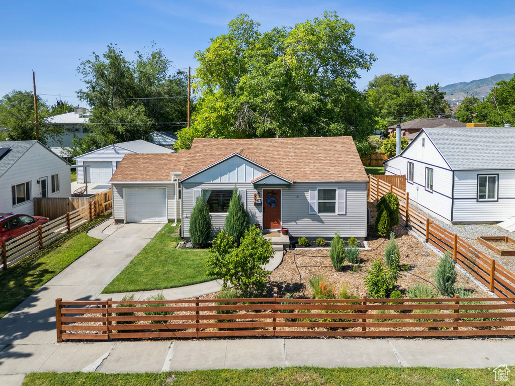 Bungalow-style house with driveway, board and batten siding, an attached garage, and a mountain view