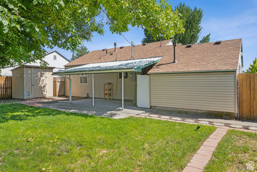 Rear view of house featuring a patio and roof with shingles