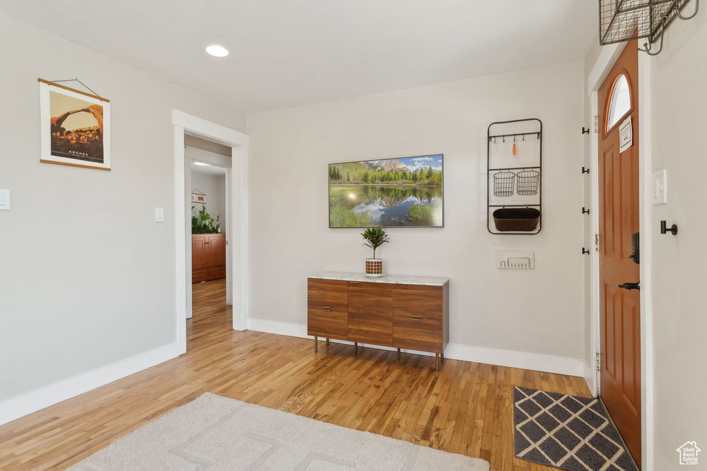 Foyer featuring wood finished floors, baseboards, and recessed lighting