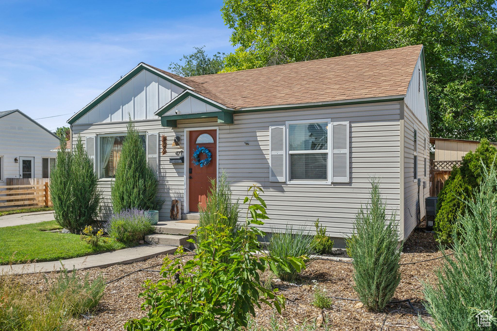 Bungalow-style home featuring board and batten siding and a shingled roof