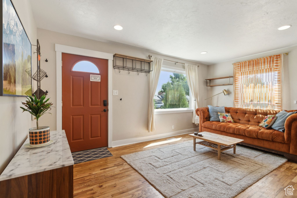 Living area featuring light wood-style flooring, recessed lighting, and baseboards