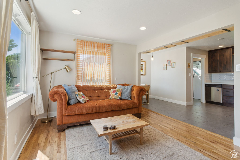 Living room featuring light wood finished floors, baseboards, and recessed lighting