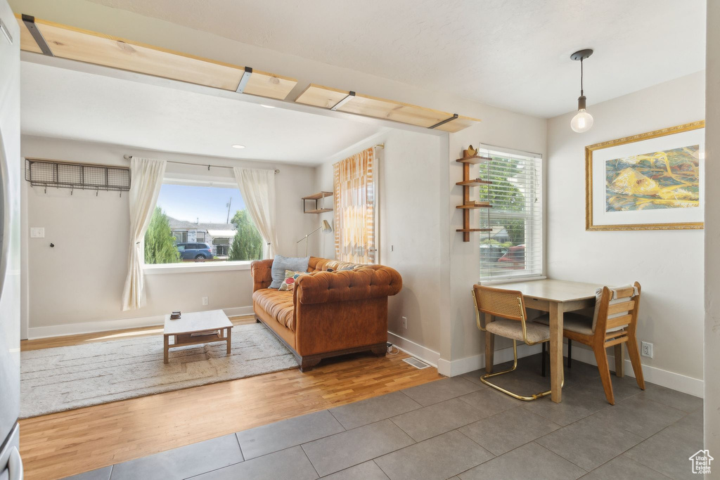Tiled living area featuring baseboards
