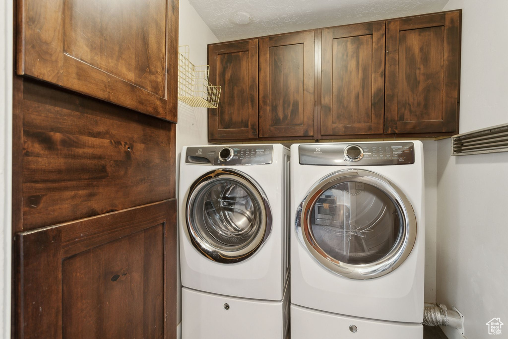 Laundry room with cabinet space and independent washer and dryer