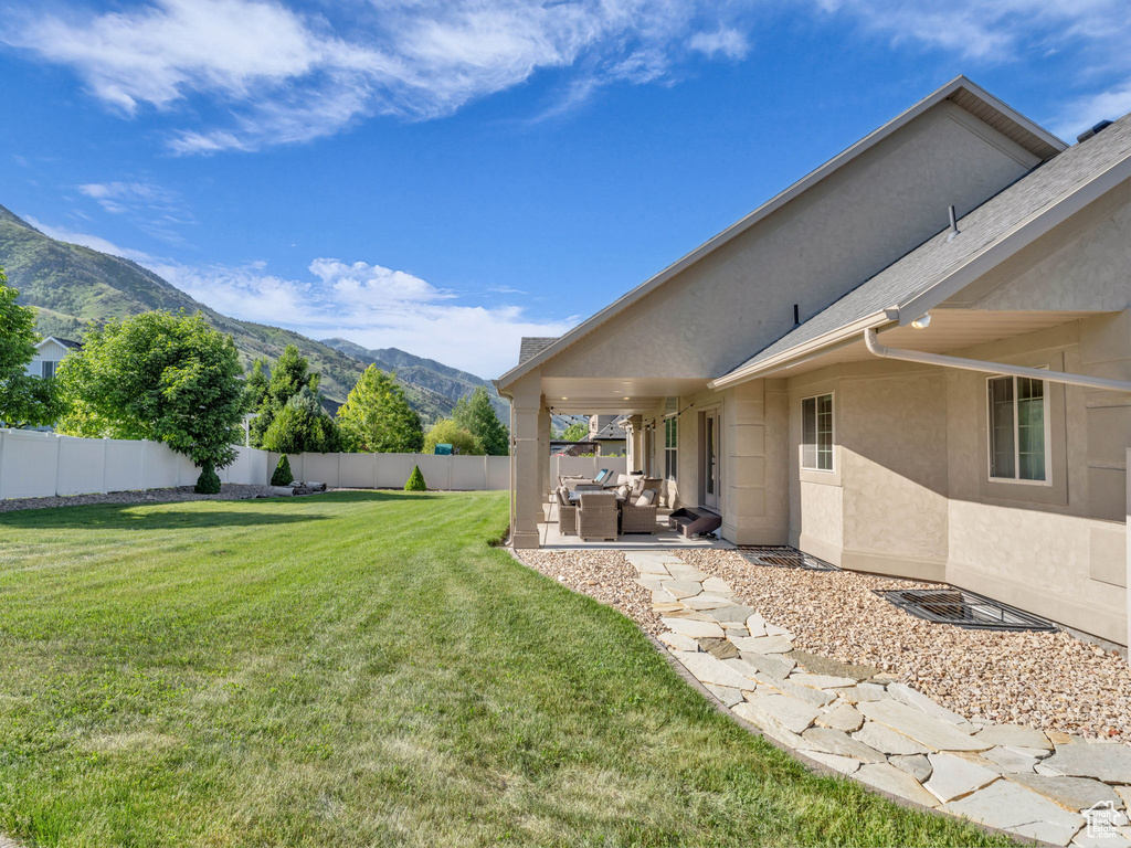 View of yard with an outdoor hangout area, a mountain view, and a patio