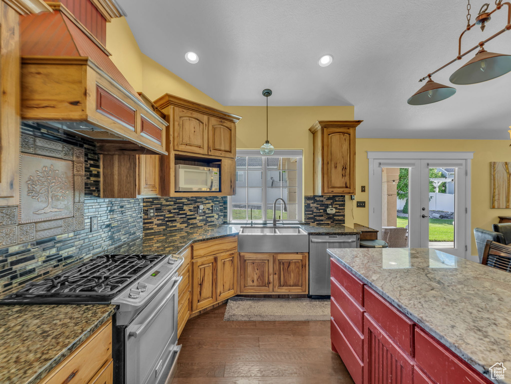 Kitchen featuring appliances with stainless steel finishes, a sink, healthy amount of natural light, french doors, and recessed lighting