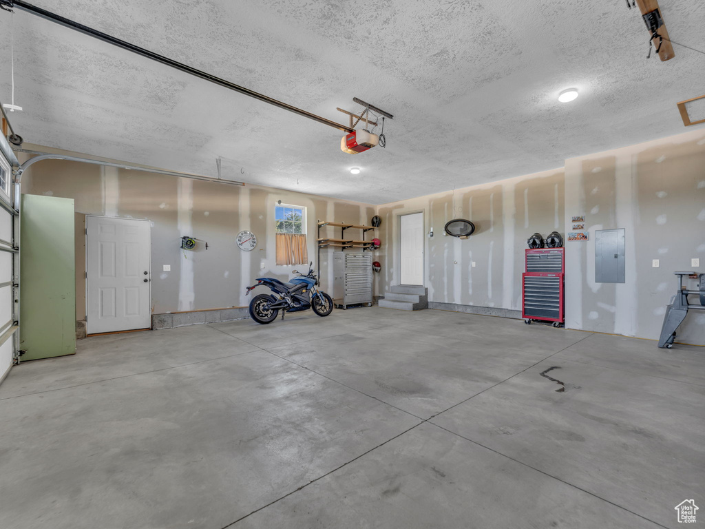 Garage with electric panel and a garage door opener