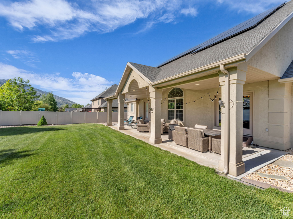 View of yard with an outdoor living space, a patio, and a mountain view