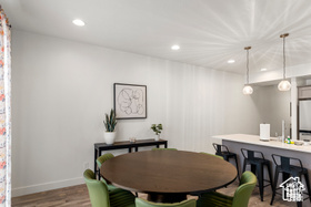 Dining room with wood finished floors, baseboards, and recessed lighting