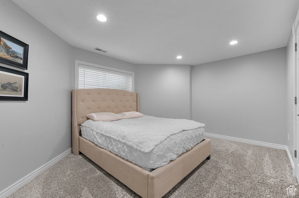 Carpeted bedroom with baseboards and recessed lighting