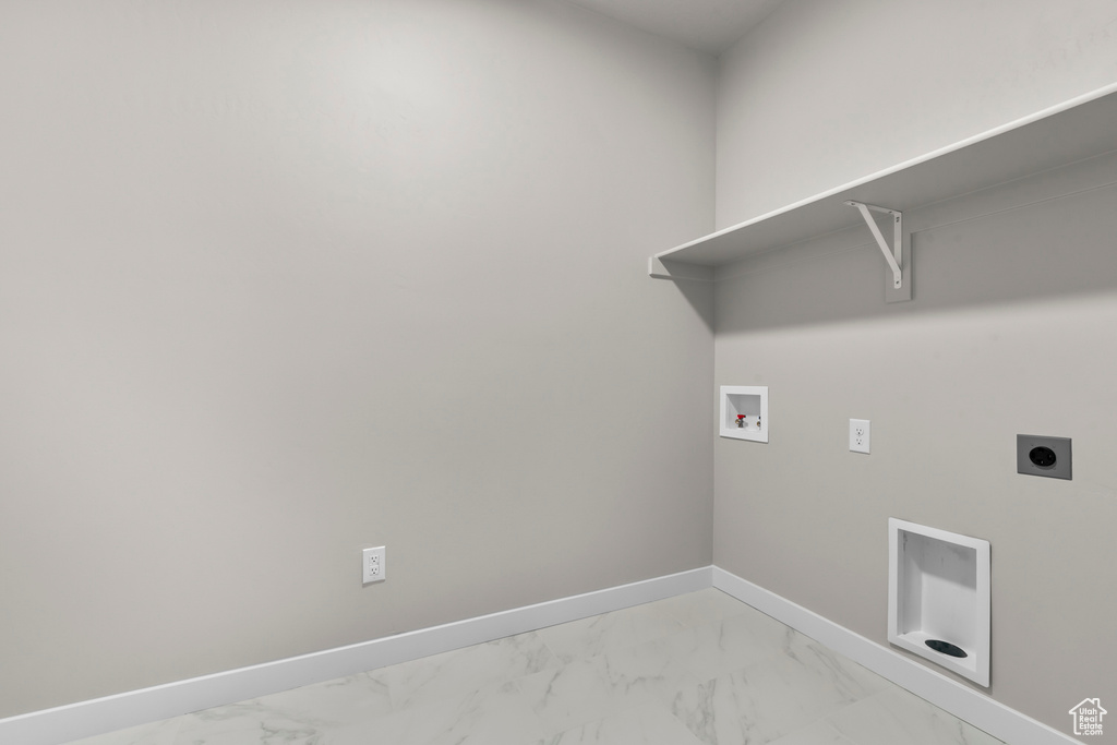 Laundry area featuring light marble finish flooring, hookup for a washing machine, electric dryer hookup, and baseboards