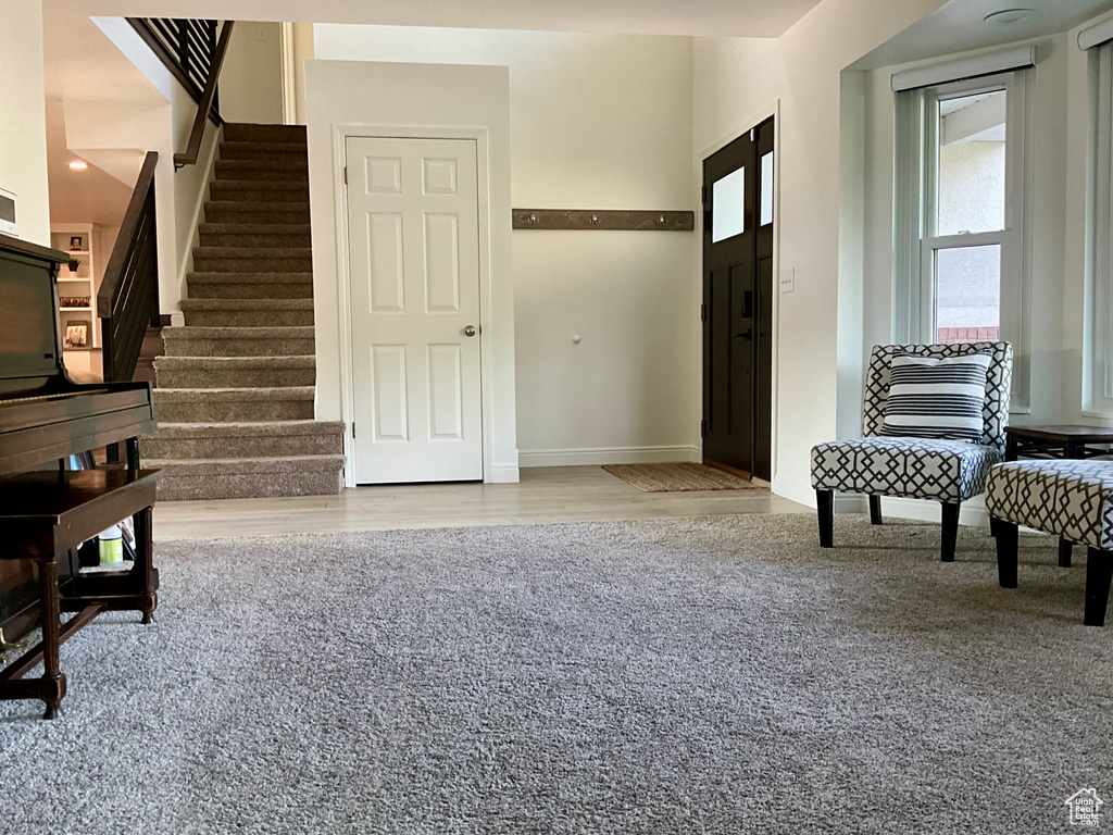 Entryway featuring stairway, baseboards, and wood finished floors