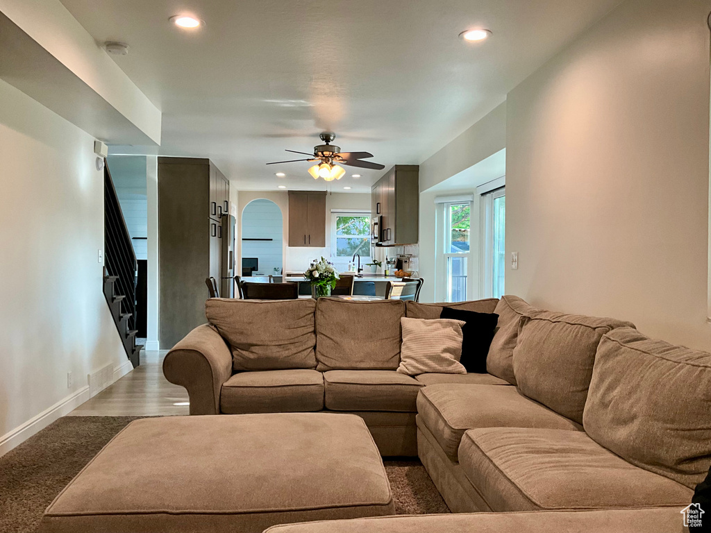 Living area featuring recessed lighting, stairway, ceiling fan, and baseboards
