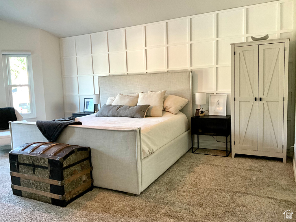 Bedroom with carpet floors and vaulted ceiling