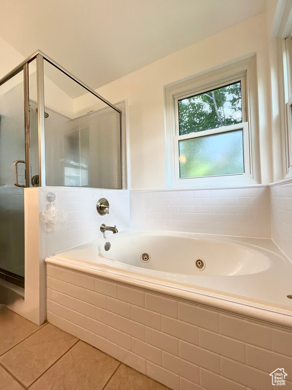 Bathroom featuring tile patterned flooring, a stall shower, and a whirlpool tub