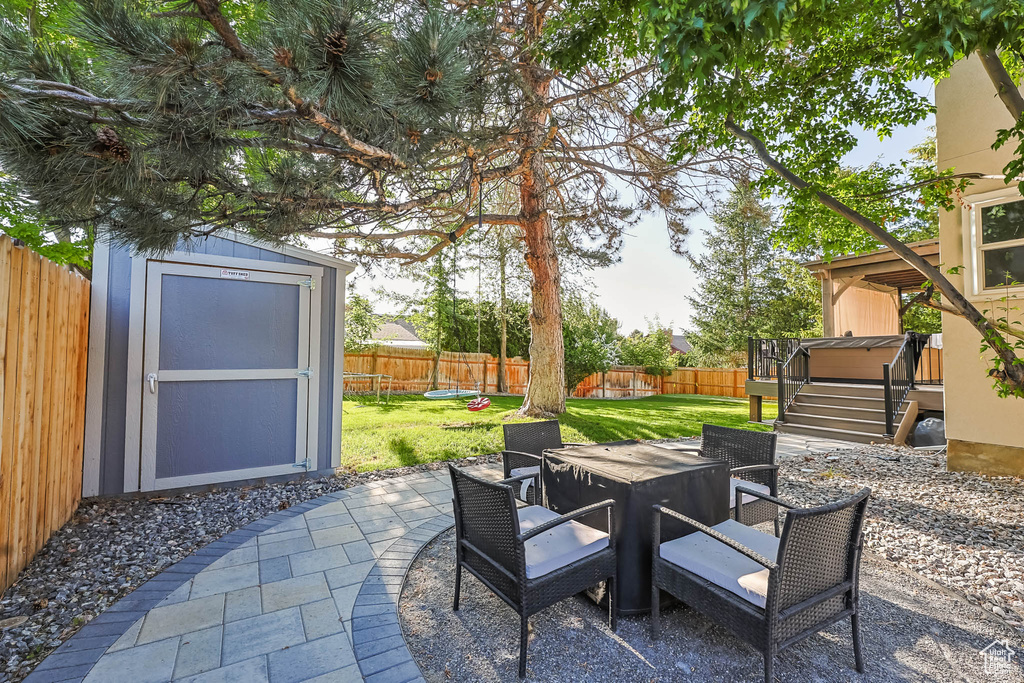 View of patio / terrace featuring a wooden deck, outdoor dining area, and stairway
