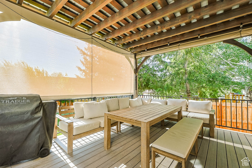 Wooden terrace featuring an outdoor living space and grilling area