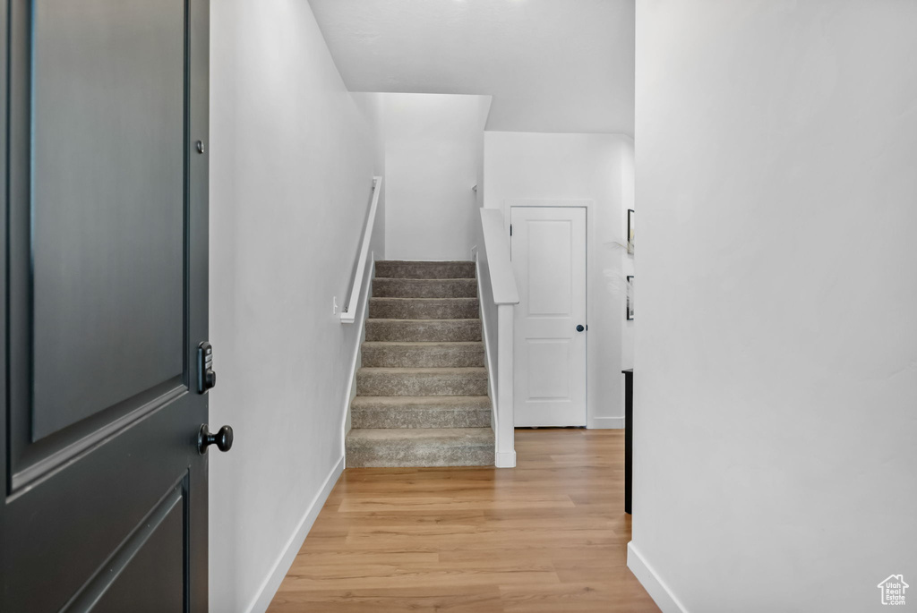 Stairway with baseboards and wood finished floors