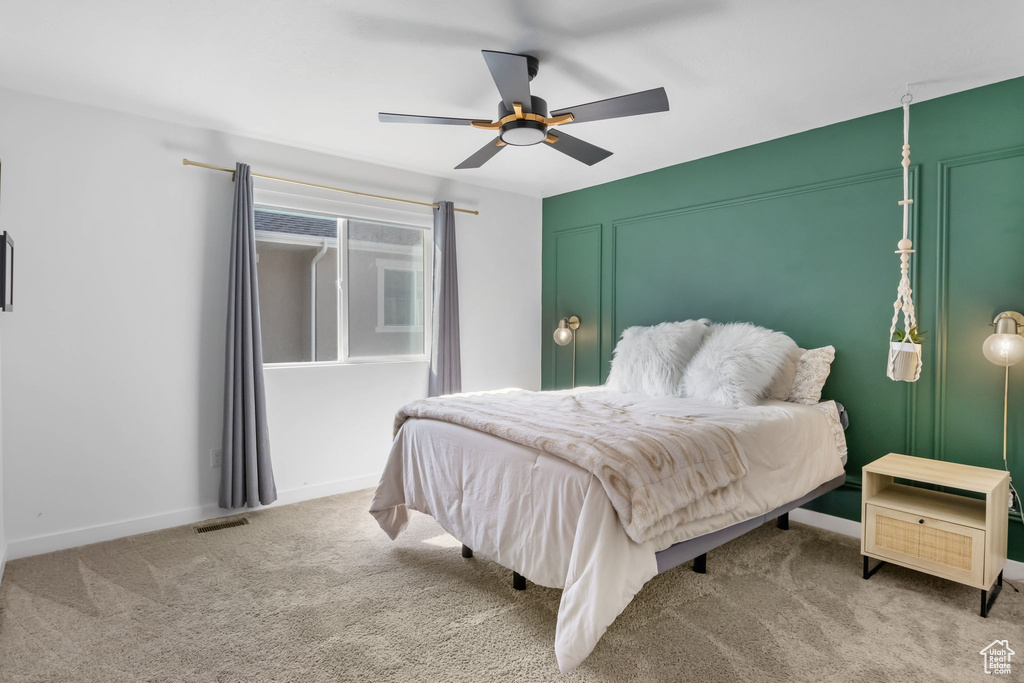 Bedroom featuring carpet, a ceiling fan, and baseboards