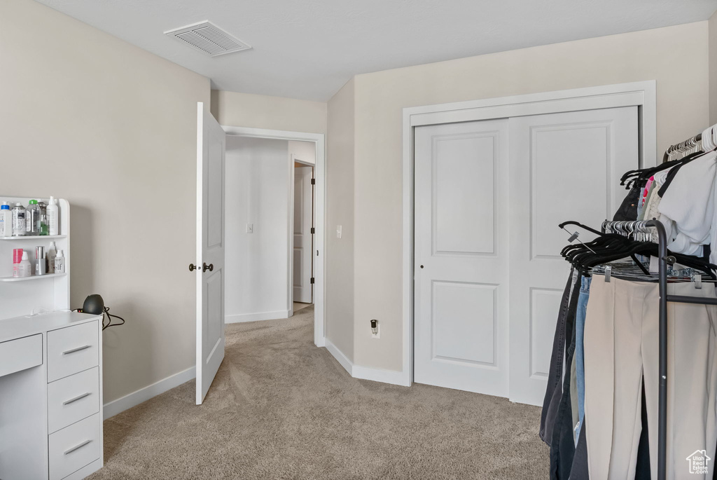 Workout room featuring light carpet and baseboards