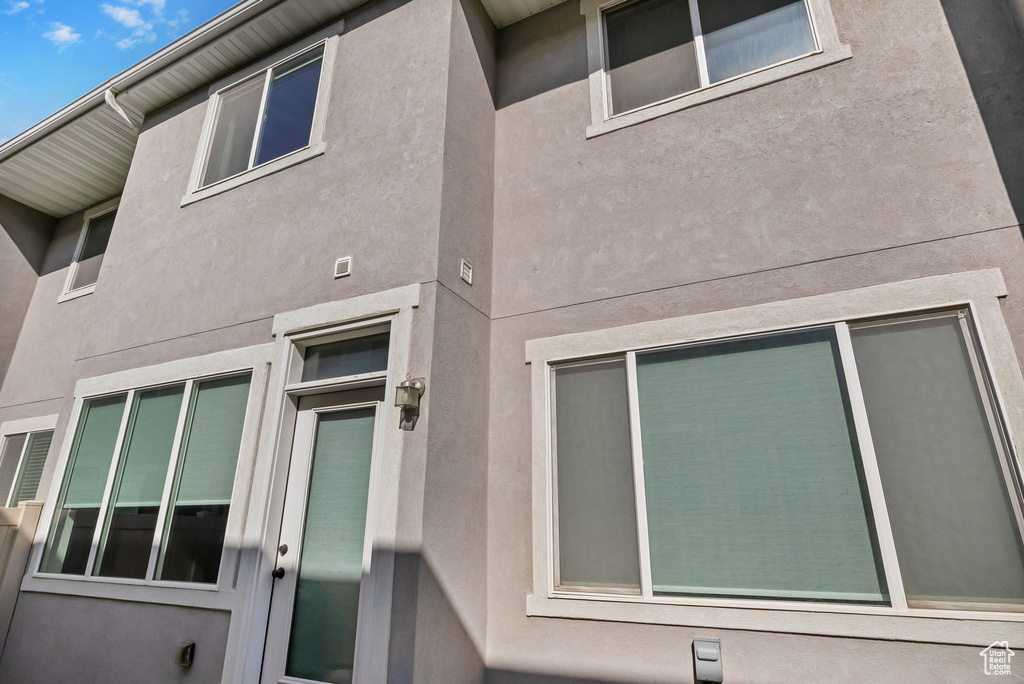 View of side of home featuring stucco siding