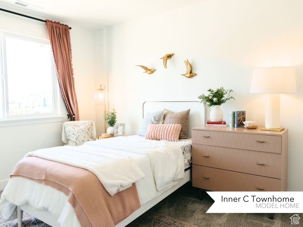 Bedroom featuring dark colored carpet