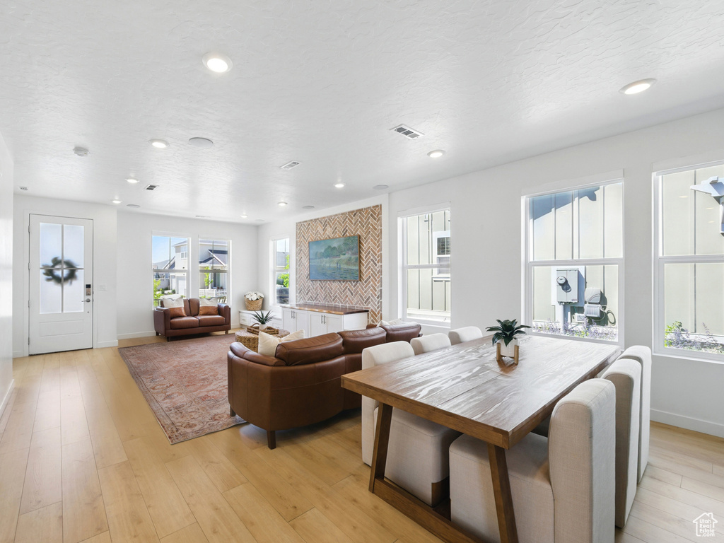 Living room with baseboards, light wood-type flooring, and recessed lighting