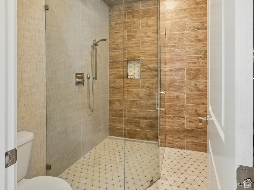 Full bath with a shower stall and toilet