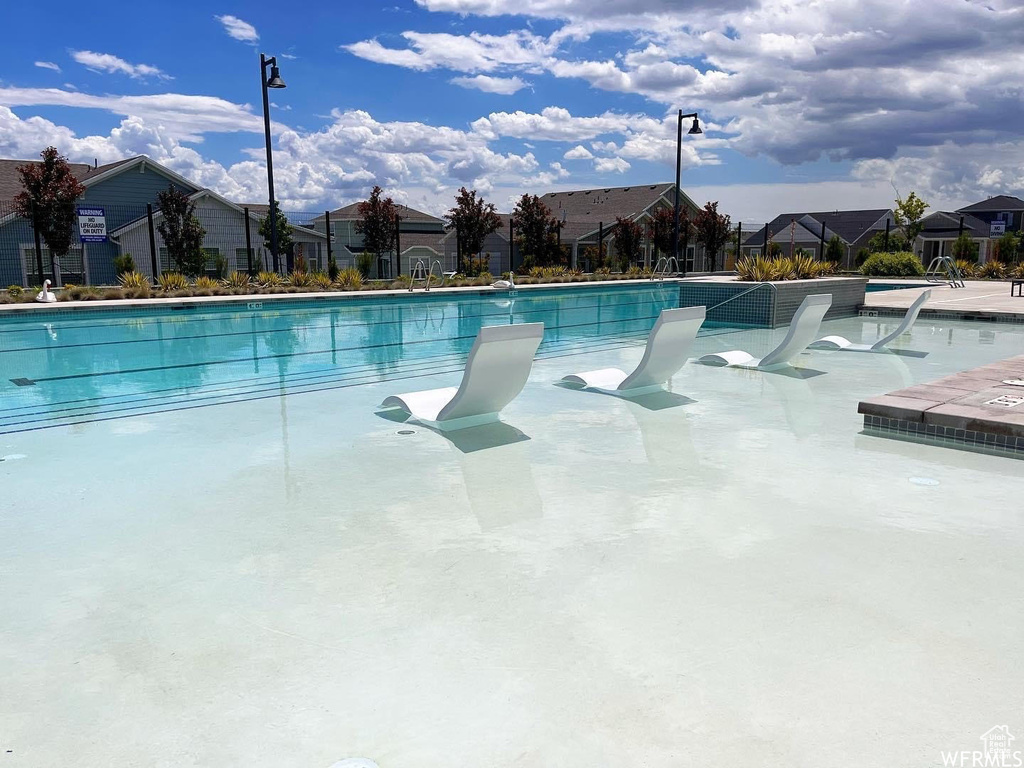Community pool with a residential view