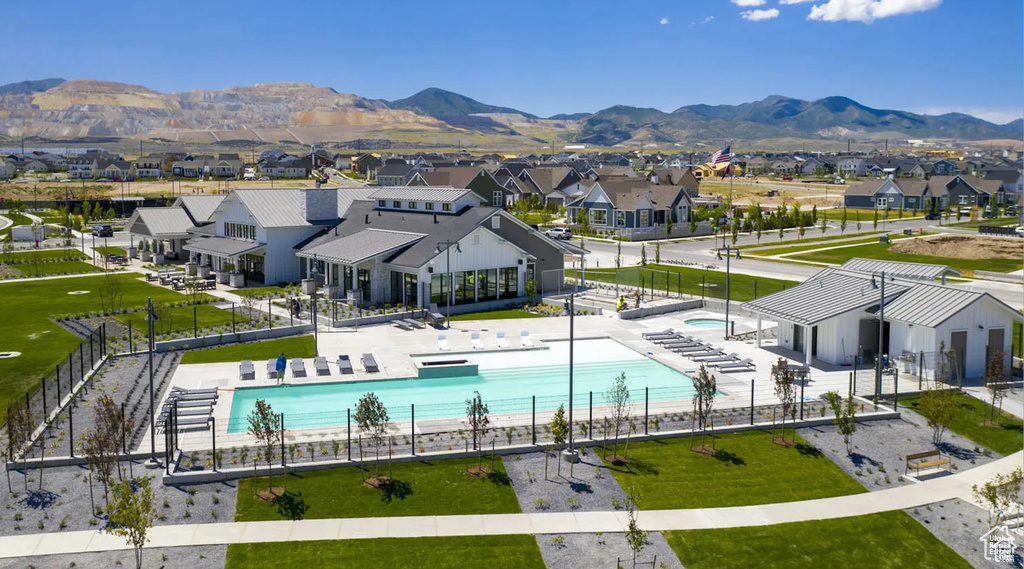 Community pool featuring a residential view and a mountain view
