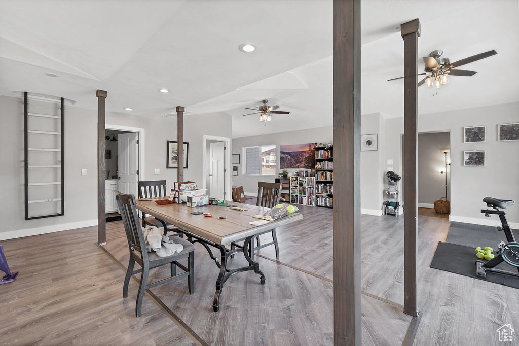 Dining room with ceiling fan, wood finished floors, baseboards, recessed lighting, and vaulted ceiling