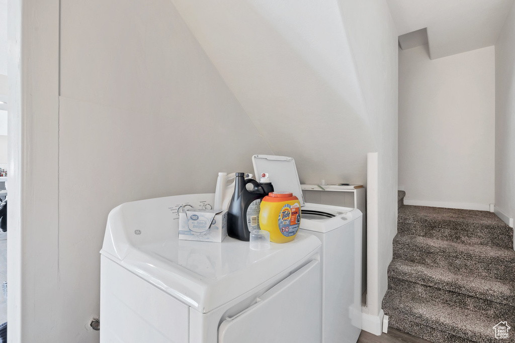 Laundry room featuring separate washer and dryer and baseboards