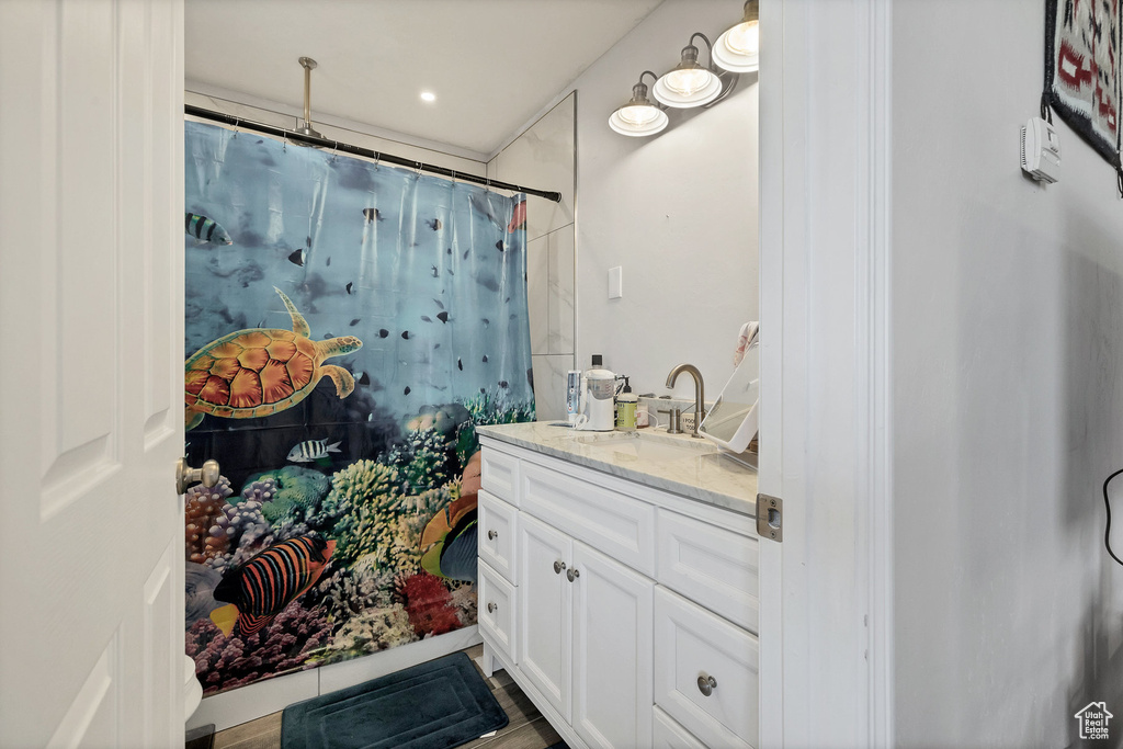 Bathroom with vanity and a shower with shower curtain