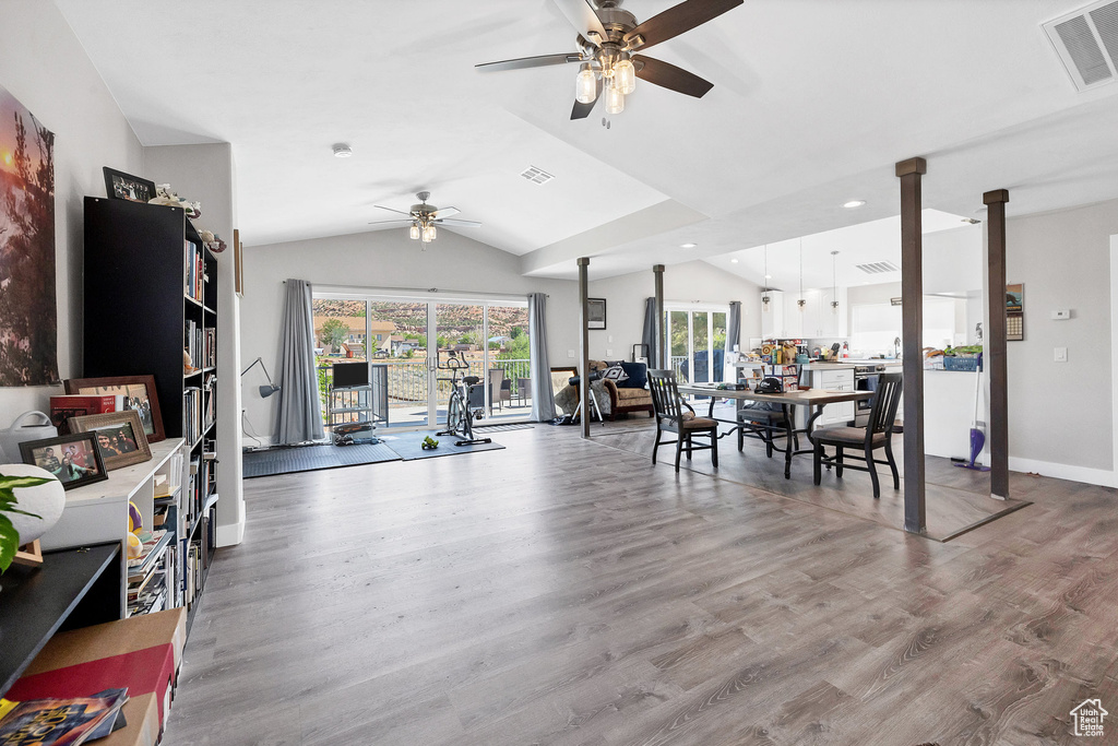 Living room featuring ceiling fan, lofted ceiling, wood finished floors, recessed lighting, and baseboards