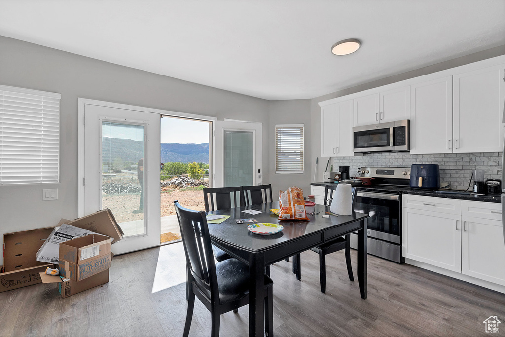 Dining area featuring wood finished floors and a mountain view