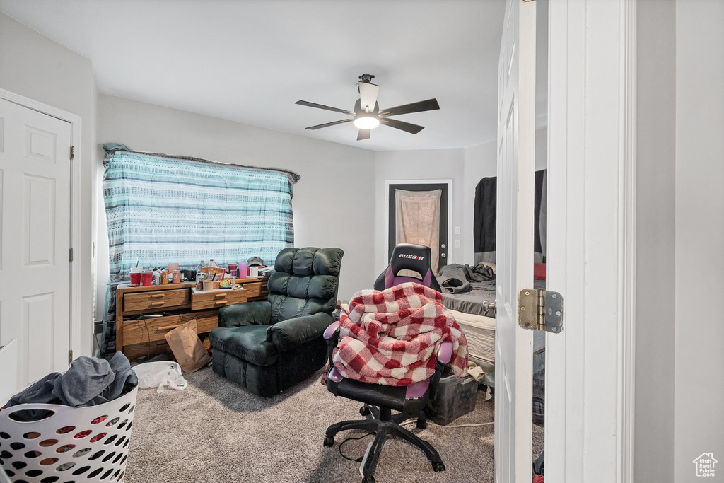 Home office with carpet flooring and a ceiling fan