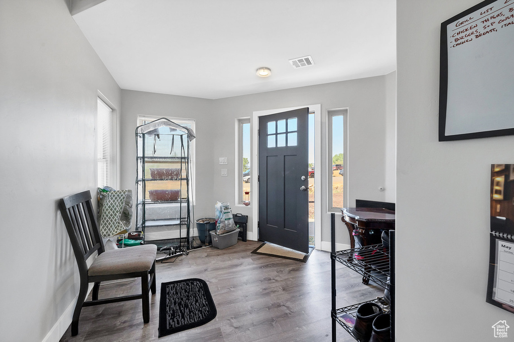 Foyer entrance featuring wood finished floors and baseboards