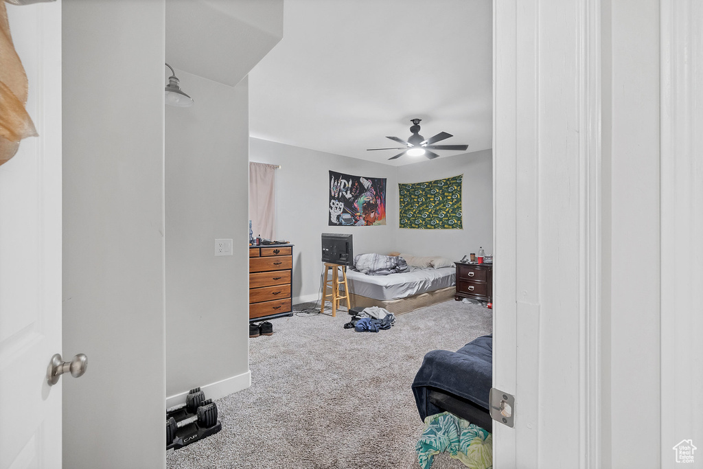Bedroom with carpet floors, baseboards, and ceiling fan