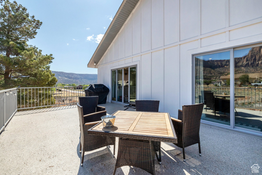 View of patio with a mountain view, area for grilling, and outdoor dining space