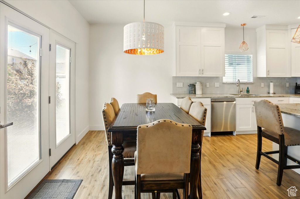 Dining area with light wood-style floors, recessed lighting, and baseboards