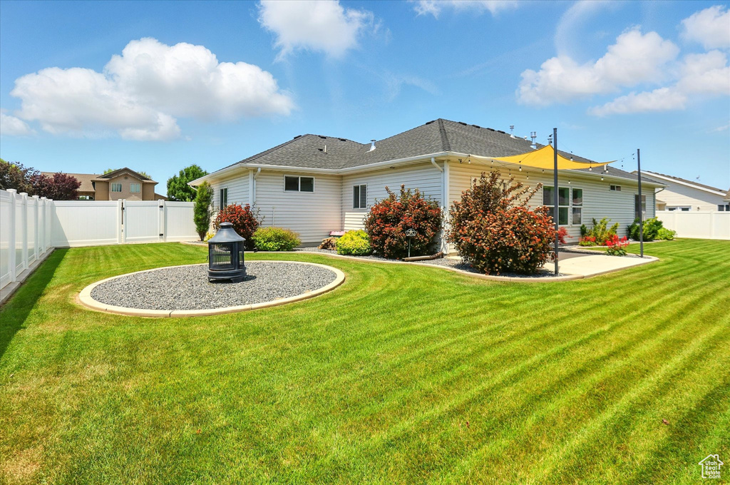 Back of house featuring a gate and a patio area