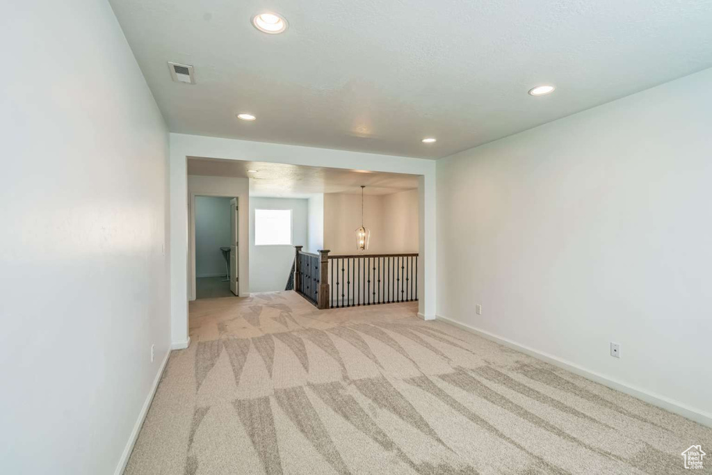 Empty room featuring light carpet and recessed lighting